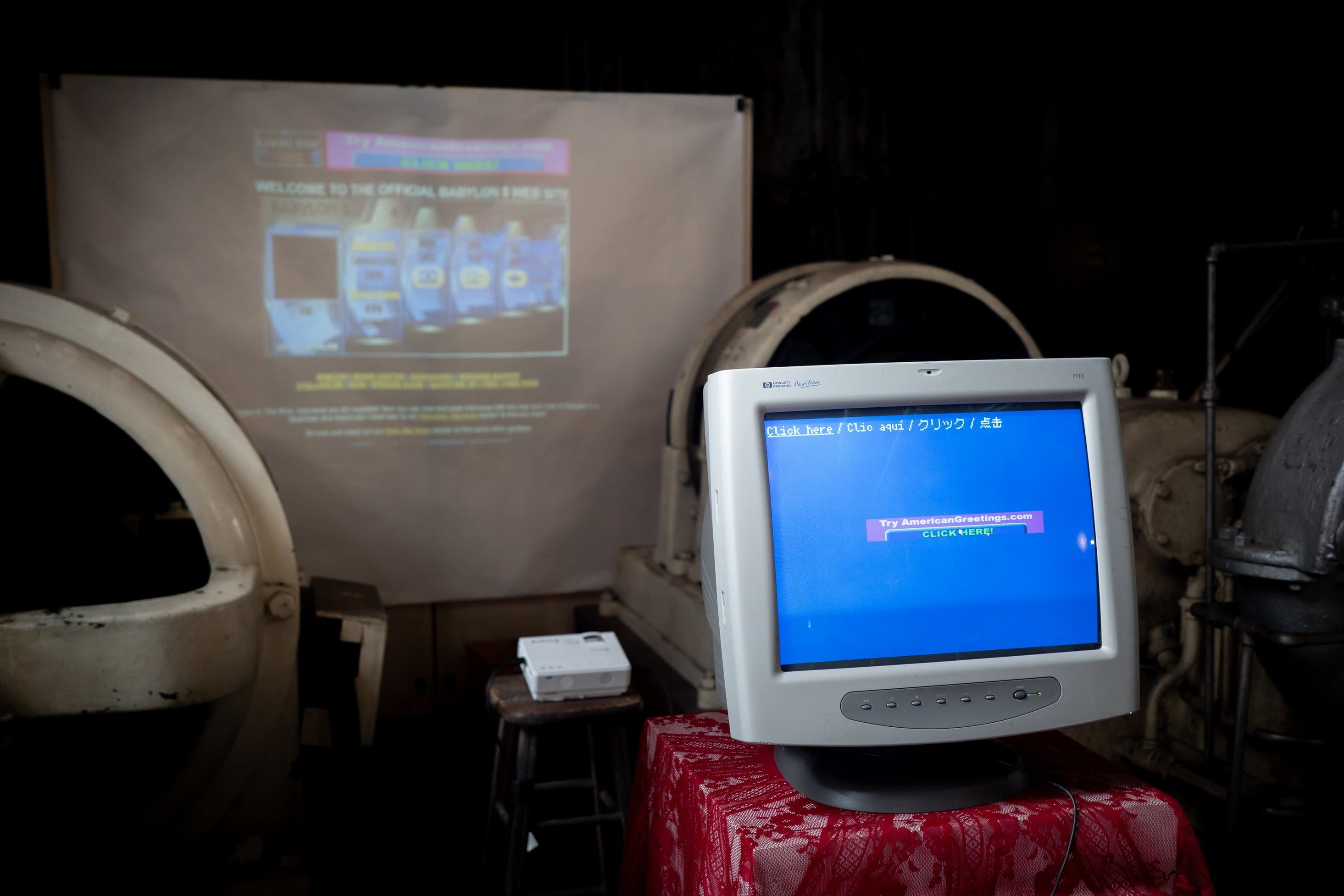 CRT monitor displaying banner ads with wall projection of the source webpage